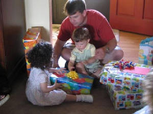 Daddy helps me open my presents