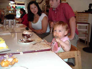 Cousin Jen looks on as Kaelyn chows down