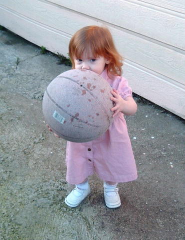 That ball is almost bigger than her